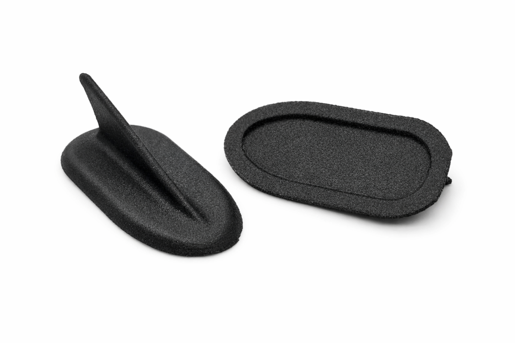 PA-CF Vortex Generators Two black silicone phone stands, one with a flat base and one with a pointed tip.